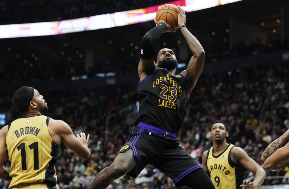 Los Angeles Lakers forward LeBron James (23) shoots as Toronto Raptors forward Bruce Brown (11) watches during the second half of an NBA basketball game Tuesday, April 2, 2024, in Toronto. (Frank Gunn/The Canadian Press via AP)