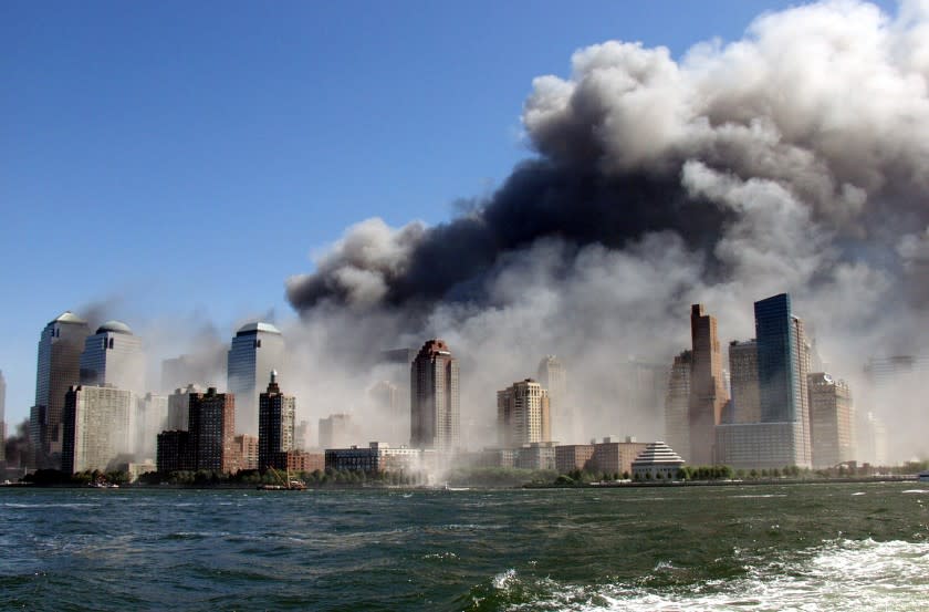 Smoke rises over the New York Skyline from the scene of the World Trade Center Attack, as seen from a tugboat evacuating people from Manhattan to New Jersey. (Photo by Hiro Oshima/WireImage)