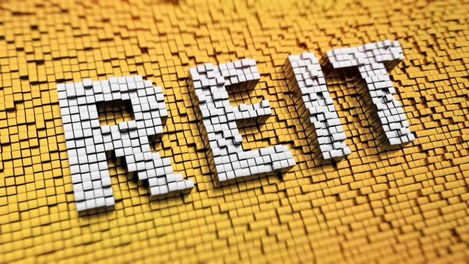 Pixelated acronym REIT made from cubes, mosaic pattern