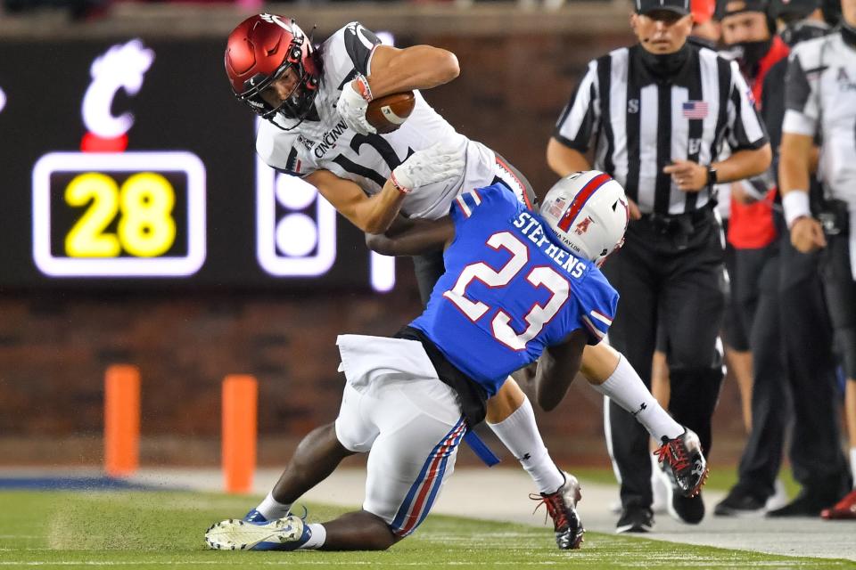 Oct 24, 2020; Dallas, Texas, USA; Cincinnati Bearcats wide receiver Alec Pierce (12) makes a reception and gets tackled by Southern Methodist Mustangs defensive back Brandon Stephens (23) during the second half at Gerald J. Ford Stadium.