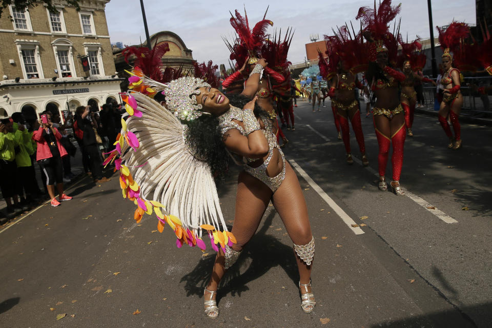 <p>Costumed revellers perform in the parade during the Notting Hill Carnival in London, Monday, Aug. 27, 2018. (Photo: Tim Ireland/AP) </p>