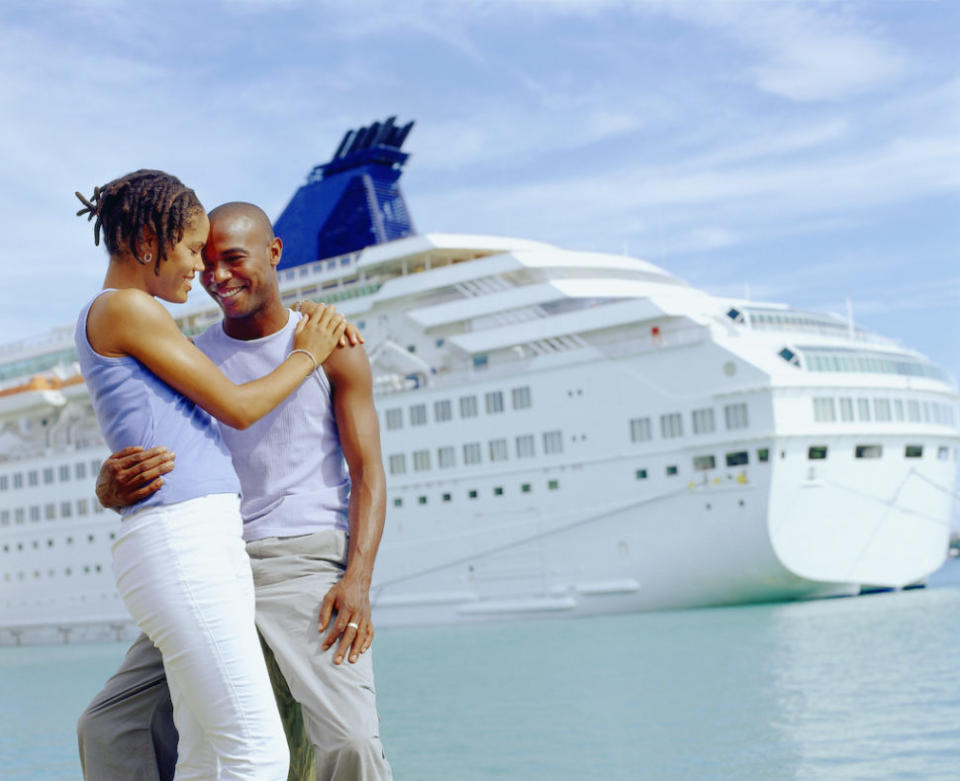 Young couple, cruise ship in background