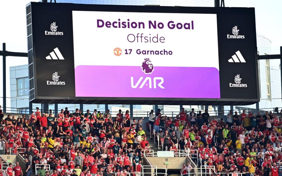 The big screen displays the decision that after a VAR (Video Assistant Referee) review a goal from Manchester United's Argentinian midfielder #49 Alejandro Garnacho is disallowed for offside