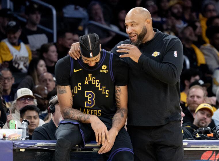 LOS ANGELES, CA - NOVEMBER 21, 2023: Los Angeles Lakers forward Anthony Davis (3) and head coach Darvin Ham share a laugh during the team's blowout win over the Utah Jazz in the second half at Crypton.com Arena on November 21, 2023 in Los Angeles, California.(Gina Ferazzi / Los Angeles Times)