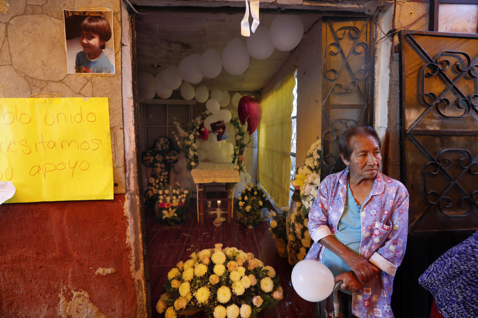 A relative of Fatima, a 7-year-old girl who was abducted from the entrance of the Enrique C. Rebsamen primary school and later murdered, waits for the arrival of her body to her home in Mexico City, Monday, Feb. 17, 2020. The girl's body was found wrapped in a bag and abandoned in a rural area on Saturday and was identified by genetic testing. (AP Photo/Marco Ugarte)