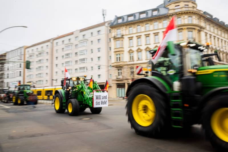 Tractors drive from the federal office of Alliance 90/The Greens (Bündnis 90/Die Grünen) to the federal office of the Free Democratic Party (FDP) during a protest with a tractor parade organized by the Brandenburg State Farmers' Association against the increase in the tax on agricultural diesel. Farmers are demonstrating nationwide on Friday ahead of the budget debates in the German Bundestag next week. Christoph Soeder/dpa