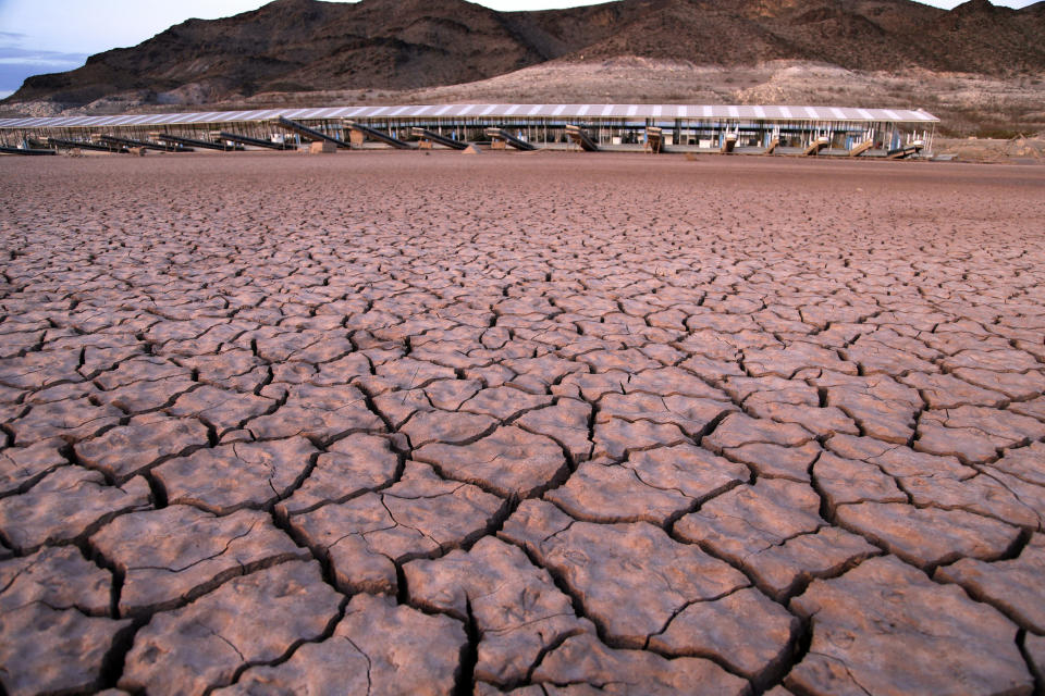 FILE - In this July 16, 2014 file photo, what was once a marina sits high and dry due to Lake Mead receding in the Lake Mead National Recreation Area in Arizona. Arizona is nearing a deadline to approve a plan to ensure a key reservoir in the West doesn't become unusable as a water source for farmers, cities, tribes and developers. Other Western states are watching. The U.S. Bureau of Reclamation expects full agreement on a drought contingency plan by Thursday, Jan. 31, 2019. (AP Photo/John Locher, File)