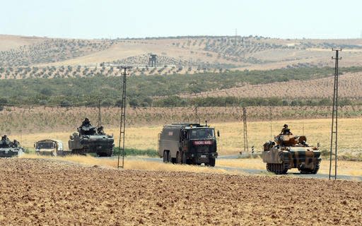 Turkish troops return from the Syrian border, in Karkamis, Turkey, Saturday, Aug. 27, 2016. Turkey on Wednesday sent tanks across the border to help Syrian rebels retake the key Islamic State-held town of Jarablus and to contain the expansion of Syria's Kurds in an area bordering Turkey.(Ismail Coskun, IHA via AP)