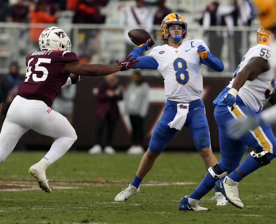 Pittsburgh quarterback Kenny Pickett (8) throws down the field while pressured by Virginia Tech defensive lineman TyJuan Garbutt (45) in the first half of an NCAA college football game, Saturday, Oct. 16, 2021, in Blacksburg, Va. (Matt Gentry/The Roanoke Times via AP)