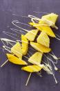 <p>Frozen mango and pineapple chunks make for an incredibly refreshing dessert, and the melted white chocolate drizzled takes this recipe the extra mile. </p><p><em><a href="https://www.womansday.com/food-recipes/food-drinks/recipes/a59412/frozen-tropical-fruit-kebabs-recipe/" rel="nofollow noopener" target="_blank" data-ylk="slk:Get the Frozen Tropical Fruit Kebabs recipe.;elm:context_link;itc:0;sec:content-canvas" class="link ">Get the Frozen Tropical Fruit Kebabs recipe.</a></em></p>