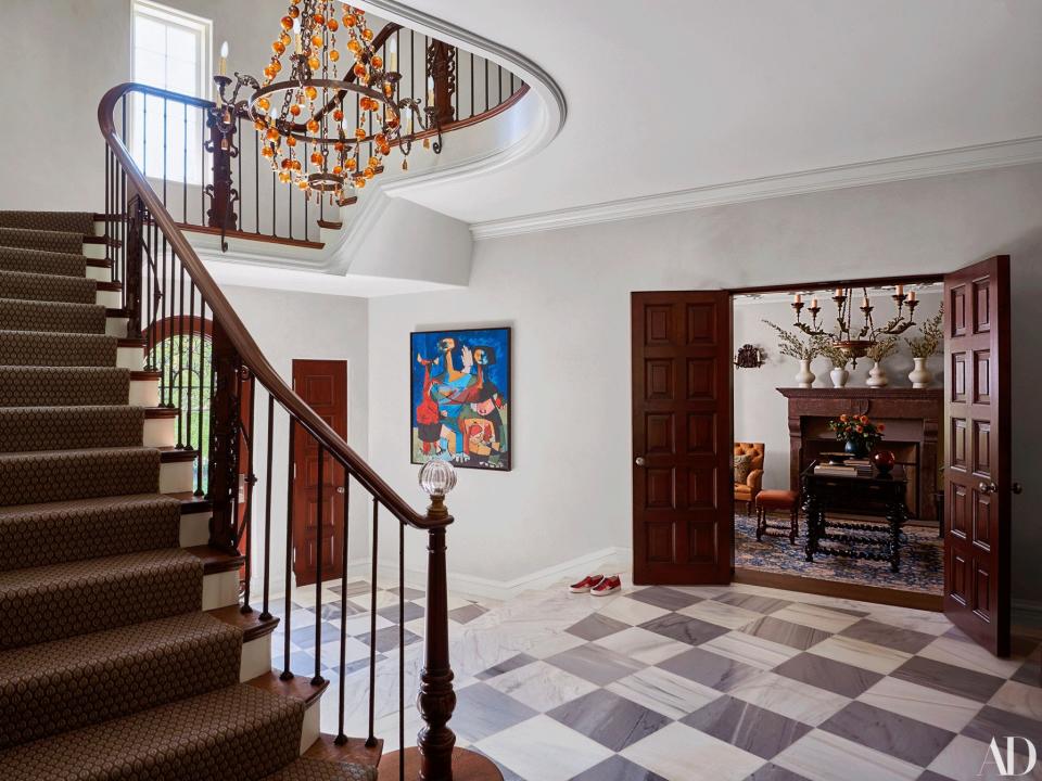 A painting by Lloyd McNeill hangs in the entry. Chandelier by Hélène Aumont.