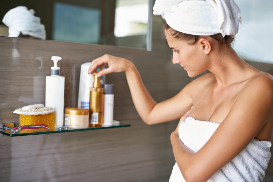 Shot of a woman wrapped on towels looking at bottles of cream in a bathroomhttp://195.154.178.81/DATA/i_collage/pi/shoots/783590.jpg