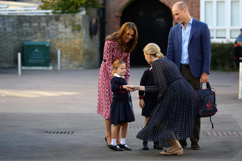 Britain's Princess Charlotte of Cambridge, accompanied by her father, Britain's Prince William, Duke of Cambridge, her mother, Britain's Catherine, Duchess of Cambridge, is greeted by Helen Haslem, head of the lower school (CR) on her arrival for her first day of school at Thomas's Battersea in London on September 5, 2019. (Photo by Aaron Chown / POOL / AFP)        (Photo credit should read AARON CHOWN/AFP/Getty Images)