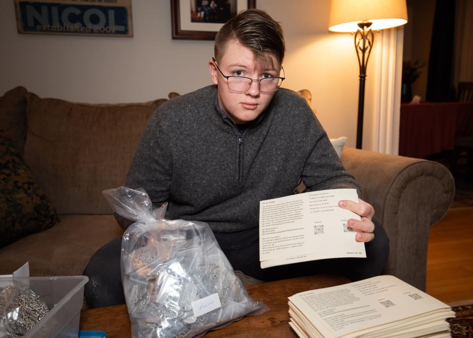 Connor Nicol, 15, of Hampton, displays the cards that he prints and pairs with the dog tags that he makes. He is currently working on honoring veterans of the Korean and Vietnam wars.