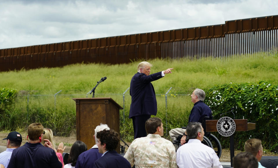 Former President Donald Trump, left, and Texas Gov. Greg Abbott, right, visit an unfinished section of border wall, in Pharr, Texas, Wednesday, June 30, 2021. (AP Photo/Eric Gay)