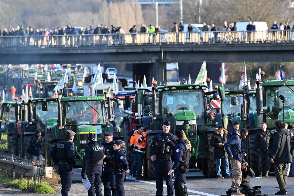 Police officers take security measures as French farmers form a convoy with their tractors and block roads as part of nationwide protests called by several farmers' unions over pay, tax and regulations, in Chilly-Mazarin district of Paris, France, Jan. 31, 2024. / Credit: Mustafa Yalcin/Anadolu/Getty