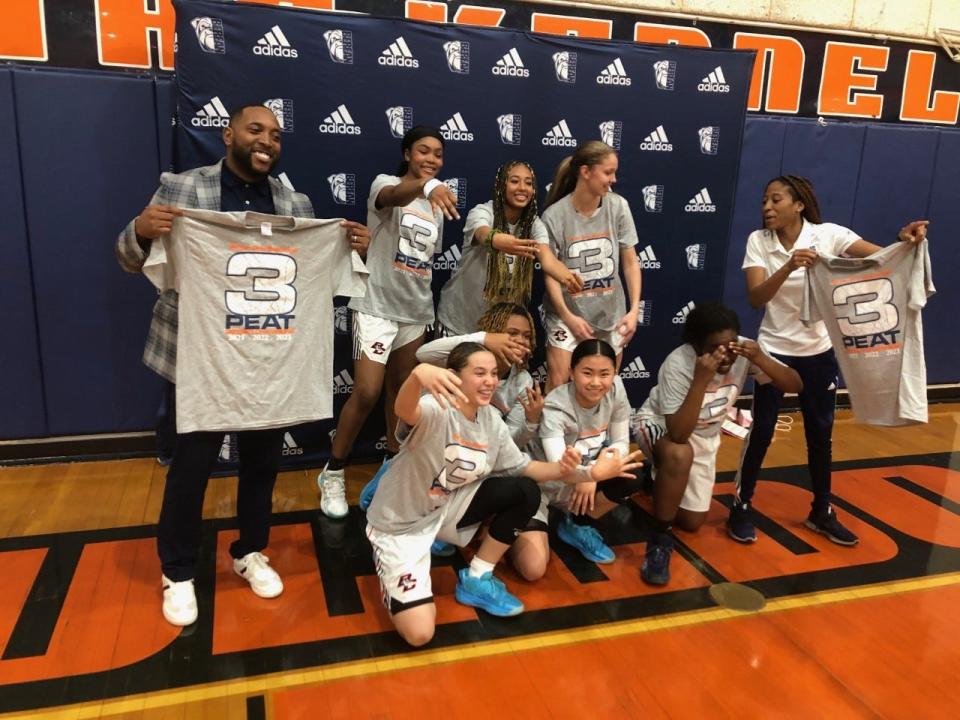 Berean Christian coach Kevin Green (left) and his players celebrate the Bulldogs' third straight district championship Friday night in West Palm Beach.