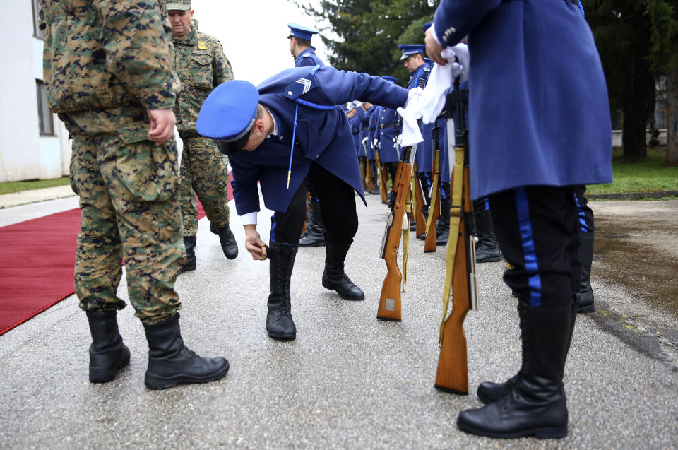 A member of the Bosnian Honor guard prepares before a ceremony in Rajlovac barracks near the capital Sarajevo, Bosnia, Friday, Dec. 10, 2021. The Bosnian Army received four US Huey II helicopters as part of US government support. (AP Photo)