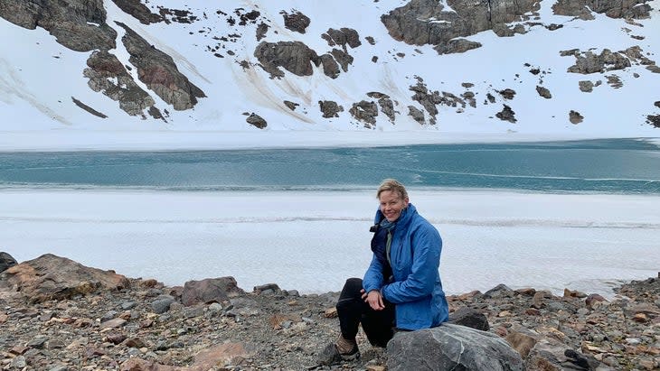 woman by alpine lake in patagonia