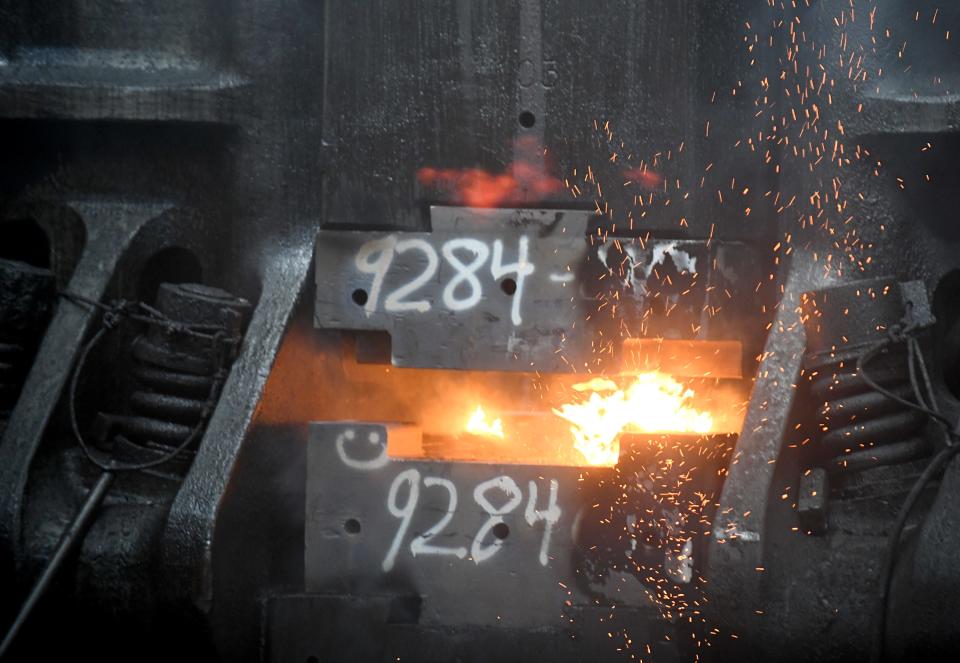 A hammer in the Canton Drop Forge plant in Perry Township presses together dies to forge a part from molten steel.