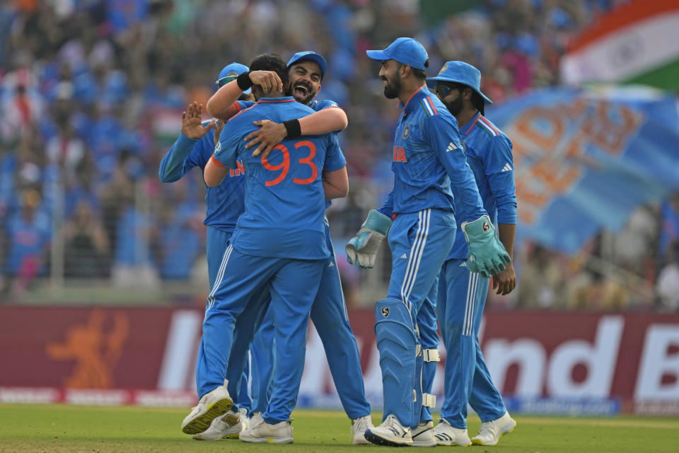 India's Jasprit Bumrah is congratulated by teammate Virat Kohli after taking the wicket of Pakistan's Mohammad Rizwan during the ICC Men's Cricket World Cup match between India and Pakistan in Ahmedabad, India, Saturday, Oct. 14, 2023. (AP Photo/Ajit Solanki)