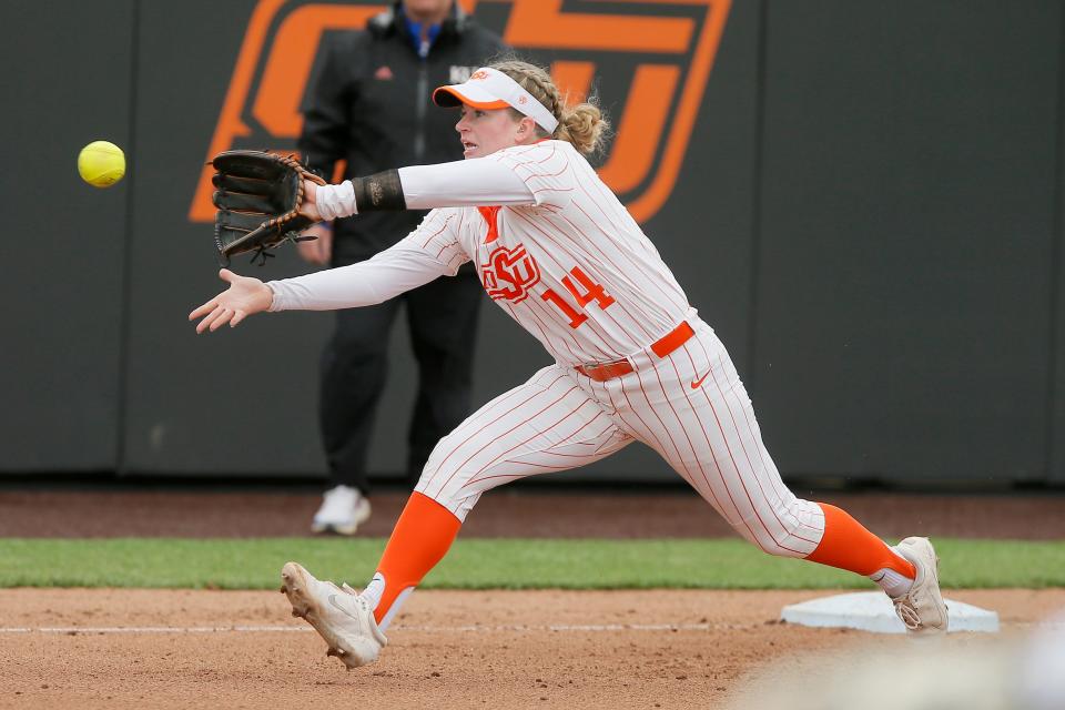 Oklahoma State's Karli Petty (14) has become extremely valuable as a versatile fielder, starting games at four different positions this season.