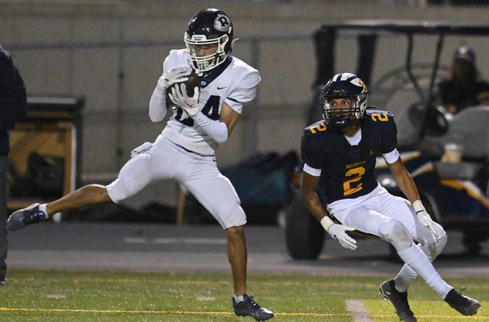 Redwood’s Dallas Harris, left, intercepts a pass intended for Sunnyside’s Malachi Barnes, right, in the Central Section D2 playoff game Friday, Nov. 3, 2023 in Fresno. Sunnyside won the game 39-21.