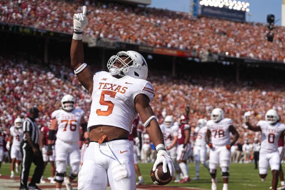 Former Texas running back Bijan Robinson (5) celebrates a touchdown during the annual Red River Showdown against Oklahoma last season. The addition of the Longhorns and Sooners to the SEC next year has forced the league to rethink its scheduling formats.