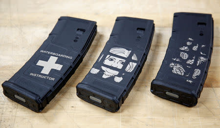 A close-up of logos engraved on 30-round-mag polymer magazines at Spike's Tactical LLC, a gunmaker in Apopka, Florida, U.S. December 10, 2018. (L-R) 'Waterboarding Instructor', 'Hillary For Prison' and 'Pineapple Grenade' engravings. Picture taken December 10, 2018. REUTERS/Gregg Newton