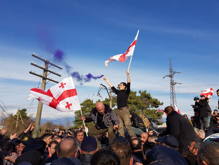 Georgian police officers block opposition supporters on the road in Mukuzani, Georgia, December 16, 2018. REUTERS/David Chkhikvishvili