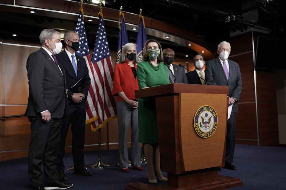 Speaker of the House Nancy Pelosi, D-Calif., meets with reporters before the House votes to pass a $1.9 trillion pandemic relief package, during a news conference at the Capitol in Washington, Friday, Feb. 26, 2021. Pelosi is joined by Majority Leader Steny Hoyer, D-Md., right, Majority Whip James Clyburn, D-S.C., third from right, and House Budget Committee Chairman John Yarmuth, D-Ky., left. (AP Photo/J. Scott Applewhite)