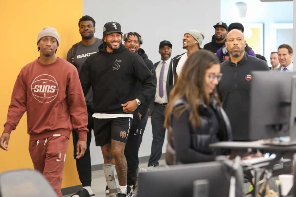 Phoenix Suns players Saben Lee, Ish Wainright, Udoka Azubuike, Jordan Goodwin, Bradley Beal and Kevin Durant walk through the United Wholesale Mortgage campus with team owner Mat Ishbia on Oct. 9, 2023, in Pontiac, Michigan.