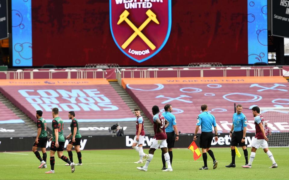 Players walk from the pitch at half time during the Premier League match between West Ham United and Aston Villa at London Stadium on July 26, 2020 in London, England. Football Stadiums around Europe remain empty due to the Coronavirus Pandemic as Government social distancing laws prohibit fans inside venues resulting in all fixtures being played behind closed doors - Getty Images Europe