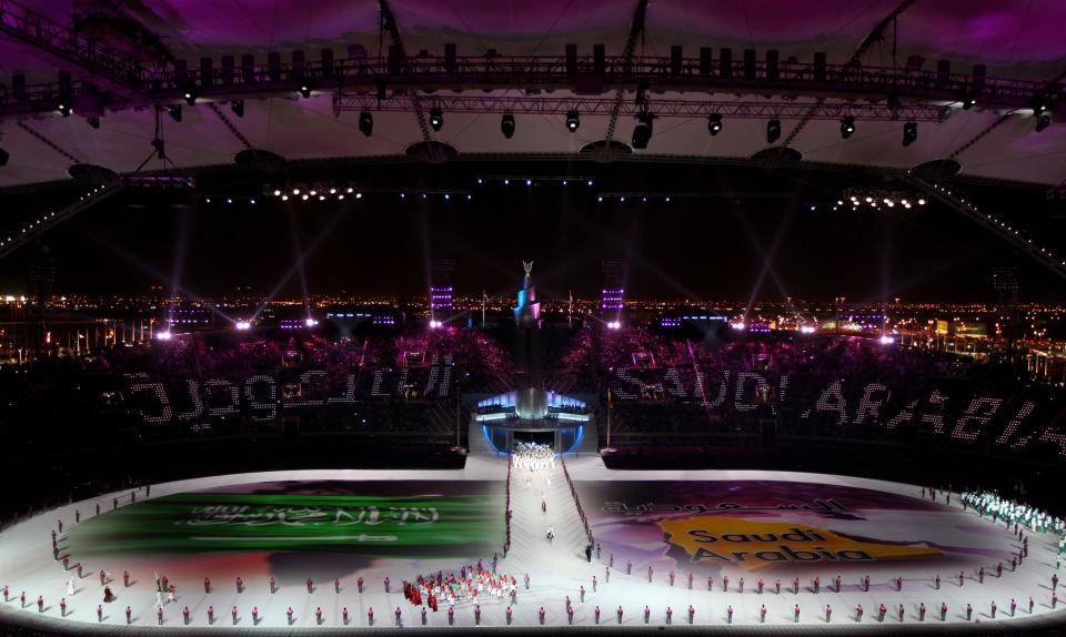 Artists perform a Saudi national flag at Sheikh Khalifa stadium during the opening ceremony of the pan-Arab Games in the Qatari capital Doha on December 9, 2011. More than 5,000 Arab athletes are participating in the Arab games from December 9 to 24. AFP PHOTO/MARWAN NAAMANI (Photo credit should read MARWAN NAAMANI/AFP/Getty Images)