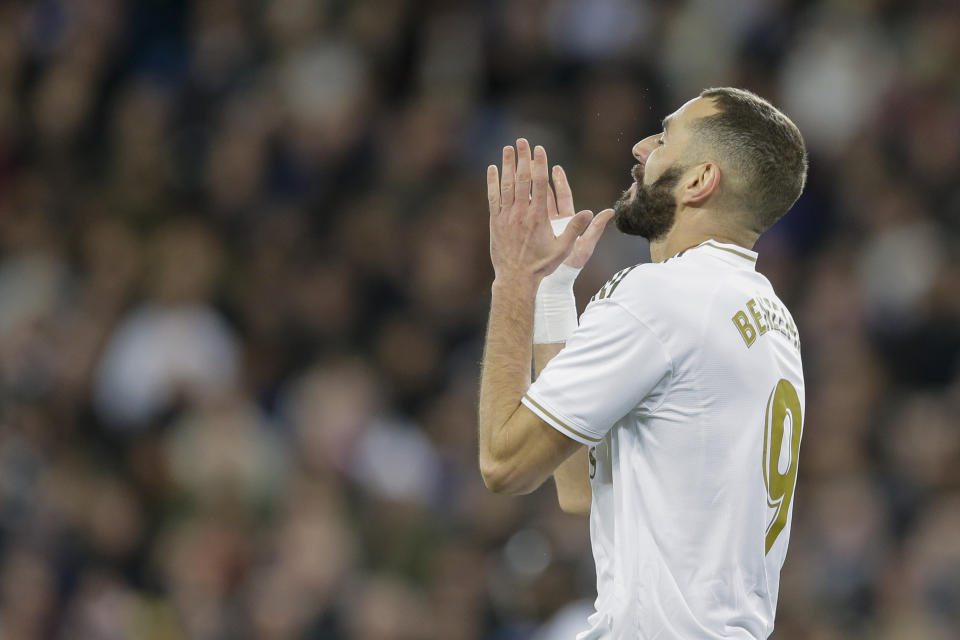 Real Madrid's Karim Benzema reacts after failing a scoring chance during a Spanish La Liga soccer match between Real Madrid and Athletic Bilbao at the Santiago Bernabeu stadium in Madrid, Spain, Sunday Dec. 22, 2019. (AP Photo/Paul White)