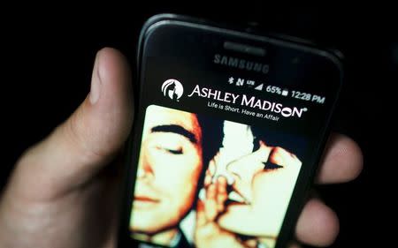 A photo illustration shows the Ashley Madison app displayed on a smartphone in Toronto, August 20, 2015. REUTERS/Mark Blinch