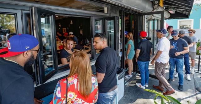 Customers line up at the ventanita and at the door of Sanguich de Miami in Little Havana. The owners and strip mall operators were sued by an ADA ‘tester’ who also has targeted hundreds of local restaurants for alleged ADA violations.