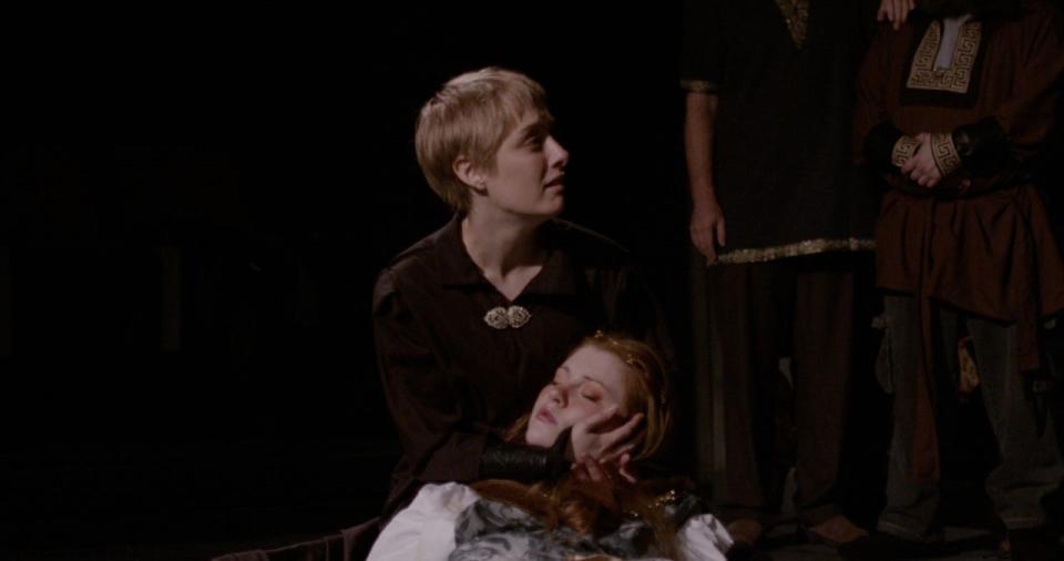 Hamlet, played by Emma Grimm, holds Ophelia, played by Molly Hull, in the Acrosstown Repertory Theater's production of 'Hamlet.'