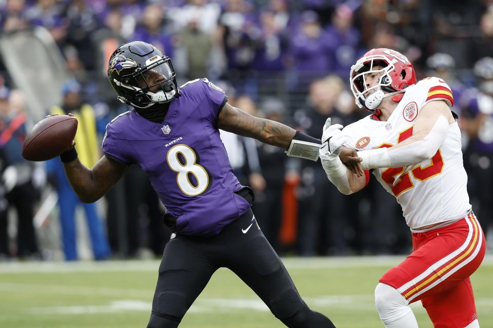 Jan 28, 2024; Baltimore, Maryland, USA; Baltimore Ravens quarterback Lamar Jackson (8) prepares to throw the ball as Kansas City Chiefs linebacker <a class="link " href="https://sports.yahoo.com/nfl/players/31962/" data-i13n="sec:content-canvas;subsec:anchor_text;elm:context_link" data-ylk="slk:Drue Tranquill;sec:content-canvas;subsec:anchor_text;elm:context_link;itc:0">Drue Tranquill</a> (23) defends during the first half in the AFC Championship football game at M&T Bank Stadium. Mandatory Credit: Geoff Burke-USA TODAY Sports