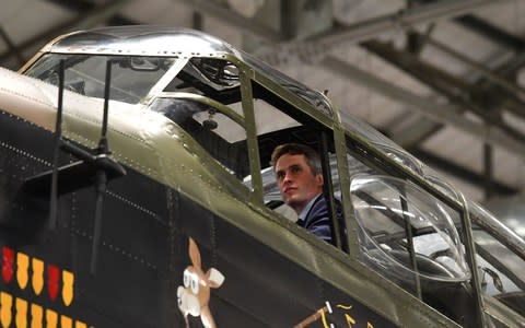 Defence Secretary Gavin Williamson looks out of the cockpit of an Avro Lancaster bomber during a visit to RAF Coningsby - Credit: PA
