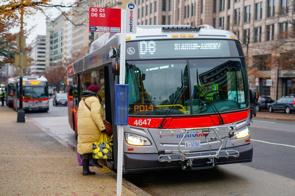 A passenger is seen boarding a Metrobus in downtown Washington, Wednesday, Dec. 7, 2022. The Washington DC government voted to waive fares for Metrobus rides within city limits starting July, 1, 2023, becoming the nation's most populous city to offer free public transit.