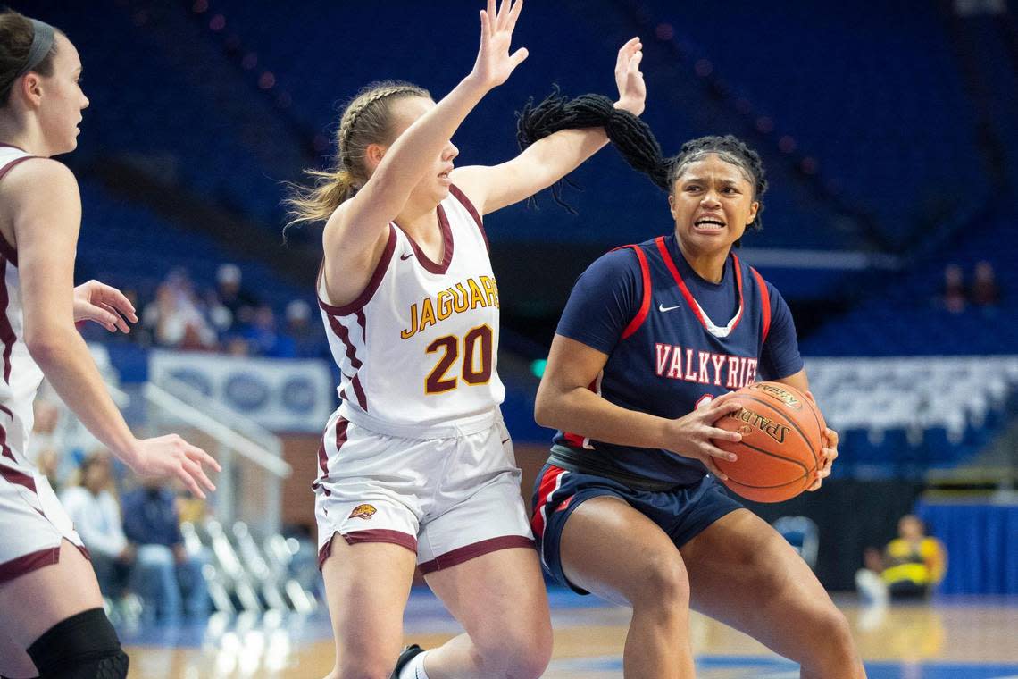 Sacred Heart’s ZaKiyah Johnson (11) looks to move the ball as Cooper’s Kay Freihofer (20) defends during the semifinals of the 2022 Mingua Beef Jerky Girls’ Basketball Sweet 16 at Rupp Arena on March 12.