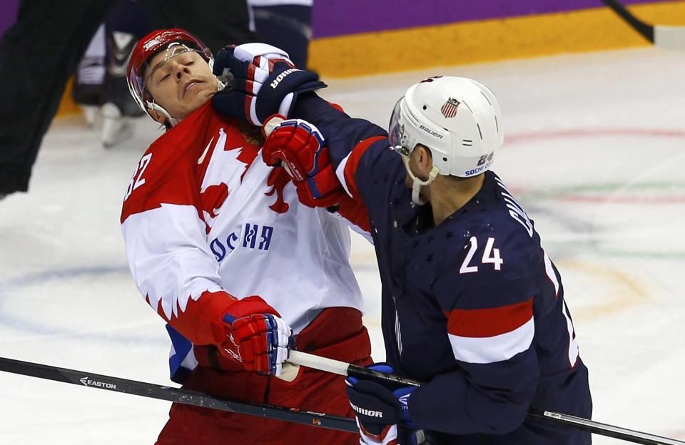 Team USA's Ryan Callahan (R) shoves Russia's Yevgeni Medvedev during the first period of their men's preliminary round ice hockey game at the 2014 Sochi Winter Olympics, February 15, 2014. REUTERS/Brian Snyder (RUSSIA - Tags: OLYMPICS SPORT ICE HOCKEY)