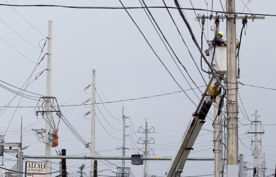 Image: Workers repair power lines in San Juan (Jose Jimenez Tirado / Getty Images file)