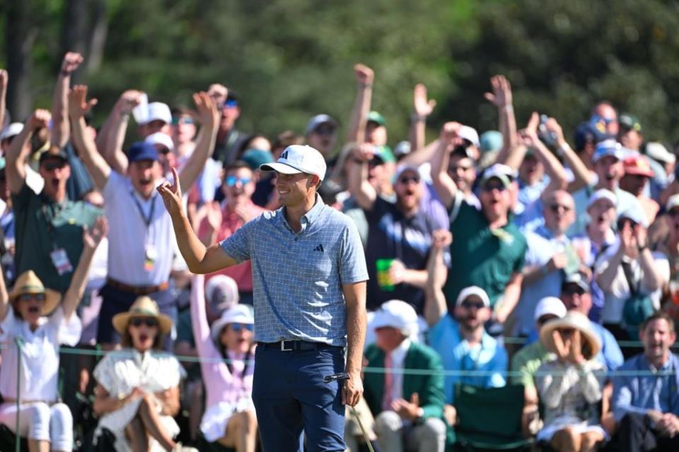 Ludvig Aberg of Sweden and the crowd react reacts after he sank a birdie putt at No. 9.