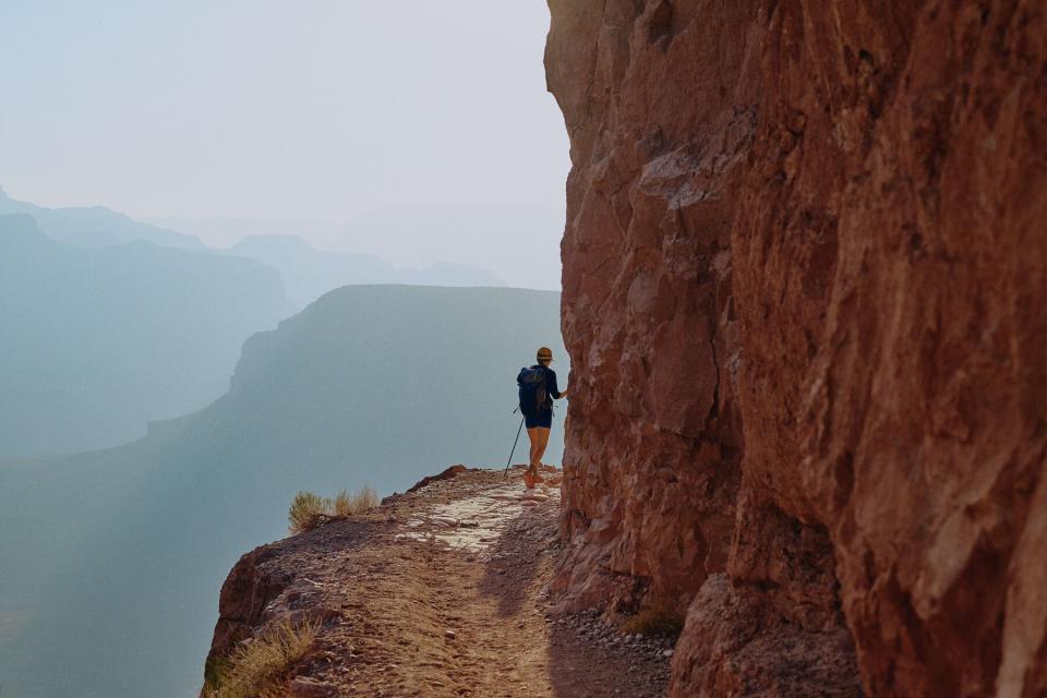 Person walking on edge of hiking path in Grand Canyon National Park