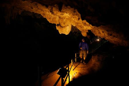 A rescue worker walks in Tham Luang caves during a search for 12 members of an under-16 soccer team and their coach, in the northern province of Chiang Rai, Thailand, June 27, 2018. REUTERS/Soe Zeya Tun/Files