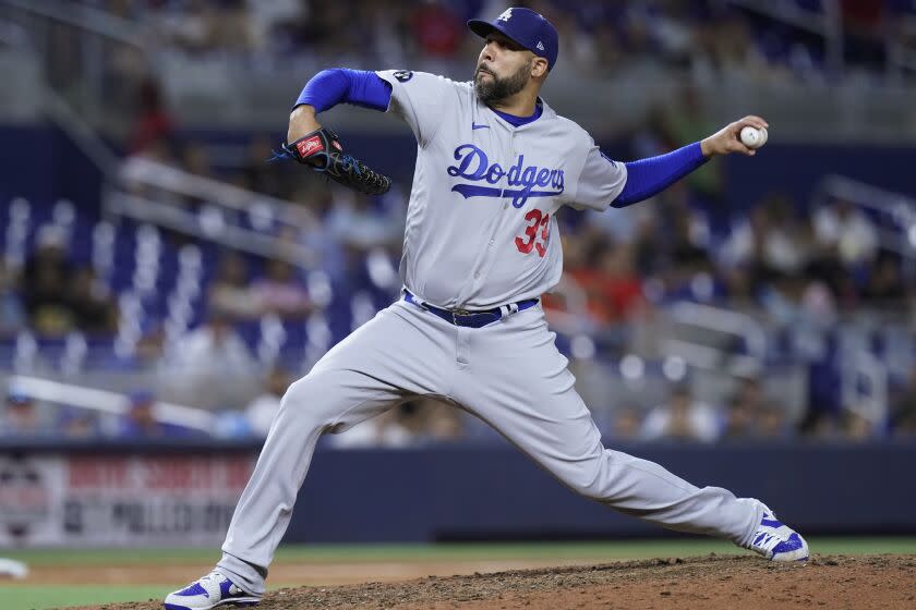 Los Angeles Dodgers relief pitcher David Price (33) aims a pitch during the ninth inning.