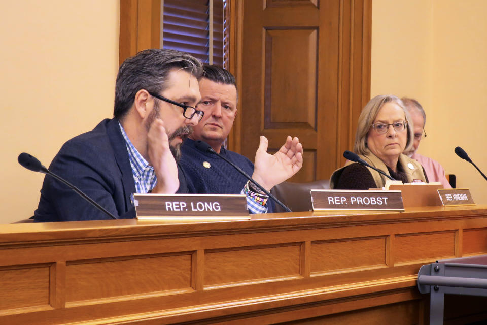 Kansas state Rep. Jason Probst, D-Hutchinson, left, makes a point about a bill on single-use plastic bags and straws as other members of the House commerce committee watch, Friday, Feb. 21, 2020, at the Statehouse in Topeka, Kan. The bill would bar cities and counties from banning such items for five years and Probst opposes it. (AP Photo/John Hanna)