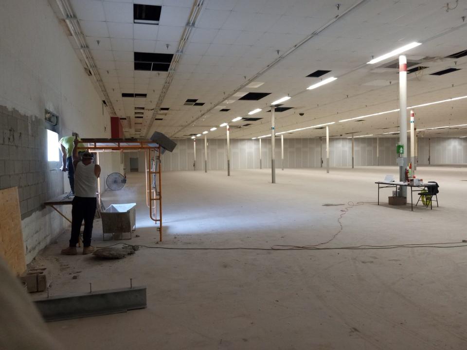 The interior of the large space that originally housed the Kmart store at the Route 6 Mall near Honesdale is seen on July 29, 2024. Hobby Lobby has signed a lease with the owner, Acadia Realty Trust, to open a retail store here. Workers are cutting an emergency exit door, at left.